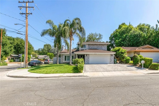 23500 Lloyd Houghton Pl, Newhall, CA 91321 - view of front of property with driveway, an attached garage, stone siding, and a front lawn