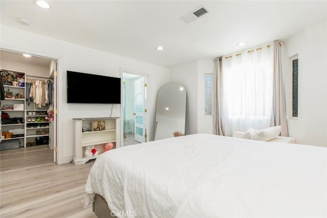 23500 Lloyd Houghton Pl, Newhall, CA 91321 - bedroom featuring a walk in closet, light wood-style floors, recessed lighting, a closet, and connected bathroom