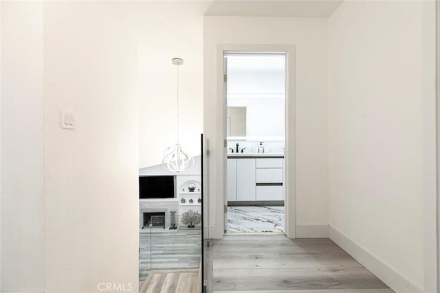 23500 Lloyd Houghton Pl, Newhall, CA 91321 - corridor with light wood-style flooring and baseboards
