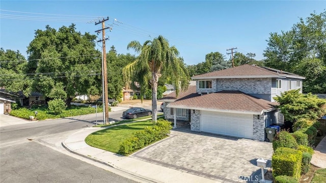 23500 Lloyd Houghton Pl, Newhall, CA 91321 - view of front of property with stone siding, a shingled roof, an attached garage, and driveway