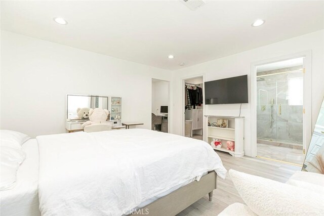 23500 Lloyd Houghton Pl, Newhall, CA 91321 - bedroom featuring recessed lighting, a spacious closet, light wood-type flooring, and ensuite bathroom