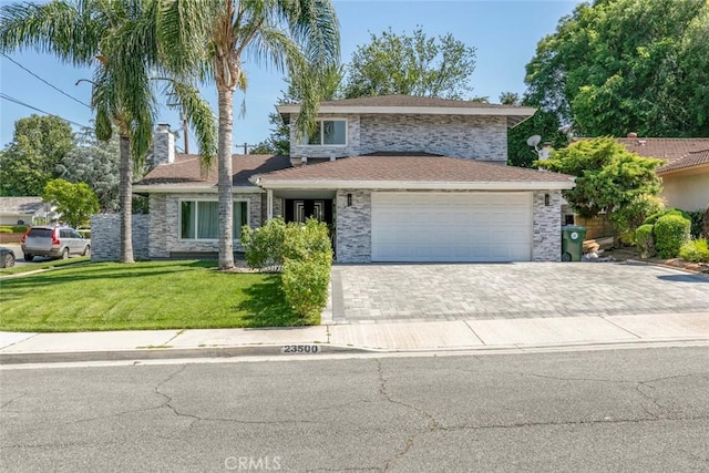 23500 Lloyd Houghton Pl, Newhall, CA 91321 - view of front facade with a front lawn, an attached garage, driveway, a chimney, and stone siding