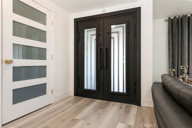 23500 Lloyd Houghton Pl, Newhall, CA 91321 - entryway with french doors and light wood-style flooring