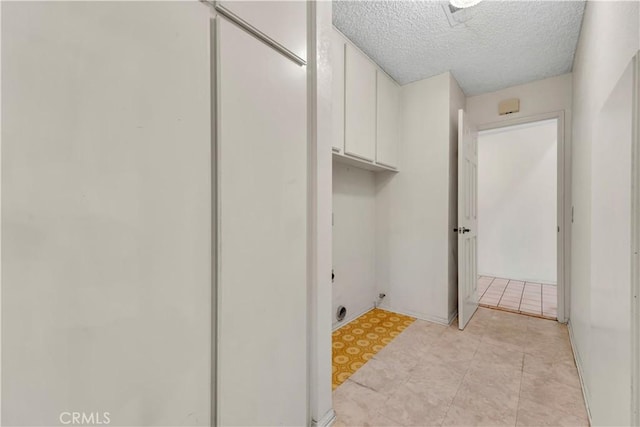 204 Hawk Ln, Palmdale, CA 93551 - washroom with cabinet space and a textured ceiling