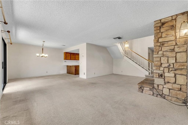 204 Hawk Ln, Palmdale, CA 93551 - unfurnished living room with light colored carpet, a chandelier, stairs, and a textured ceiling