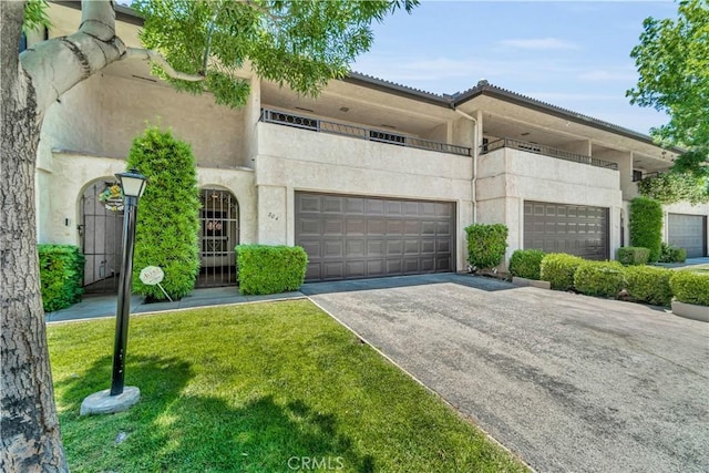 204 Hawk Ln, Palmdale, CA 93551 - view of front of house with an attached garage, stucco siding, driveway, and a front lawn