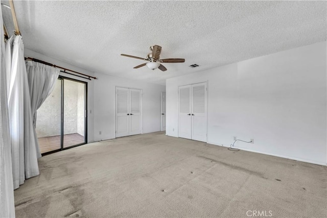 204 Hawk Ln, Palmdale, CA 93551 - unfurnished bedroom with access to exterior, carpet, a textured ceiling, multiple closets, and ceiling fan
