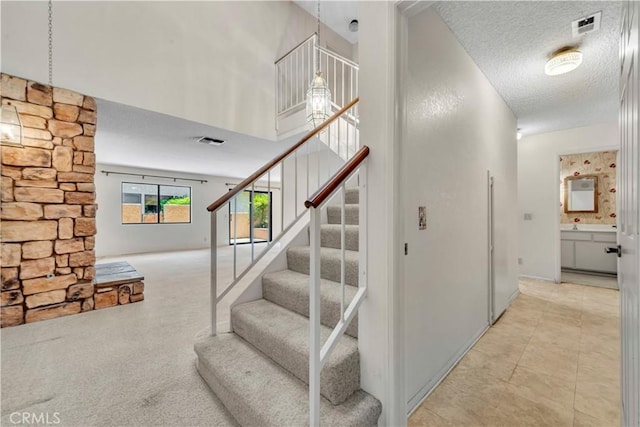 204 Hawk Ln, Palmdale, CA 93551 - stairs with a textured ceiling and a towering ceiling