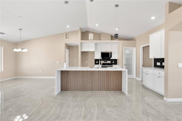 20020 Symeron Rd, Apple Valley, CA 92307 - kitchen featuring stainless steel appliances, tasteful backsplash, light countertops, lofted ceiling, and white cabinetry