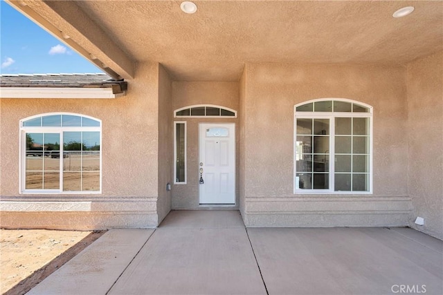 20020 Symeron Rd, Apple Valley, CA 92307 - doorway to property with stucco siding and a patio area