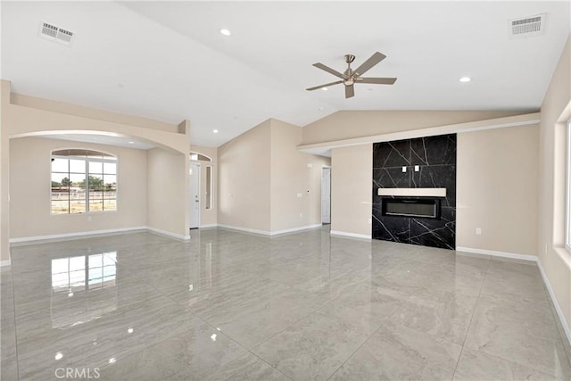20020 Symeron Rd, Apple Valley, CA 92307 - unfurnished living room featuring a ceiling fan, lofted ceiling, arched walkways, marble tiled floors, and a high end fireplace