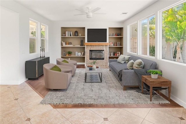 967 Strawberry Creek St, Chula Vista, CA 91913 - living area with healthy amount of natural light, tile patterned floors, ceiling fan, and a fireplace