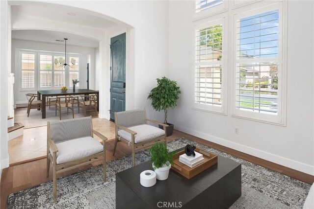 967 Strawberry Creek St, Chula Vista, CA 91913 - living room featuring arched walkways, healthy amount of natural light, wood finished floors, and a chandelier
