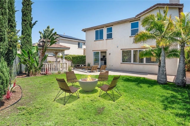 967 Strawberry Creek St, Chula Vista, CA 91913 - rear view of property with an outdoor fire pit, stucco siding, a gazebo, and a chimney