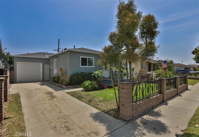 5021 Harbor St, Commerce, CA 90040 - view of front of property featuring stucco siding, an attached garage, and concrete driveway