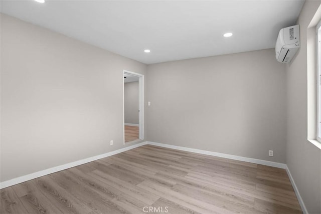 5021 Harbor St, Commerce, CA 90040 - spare room with wood finished floors, a wall mounted air conditioner, and recessed lighting