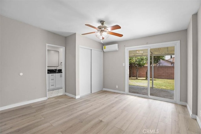 5021 Harbor St, Commerce, CA 90040 - spare room with light wood-style floors, a ceiling fan, and a wall mounted AC