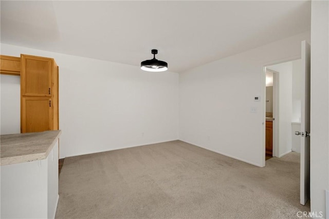 2521 W Sunflower Ave Unit R8, Santa Ana, CA 92704 - unfurnished dining area with light carpet and baseboards