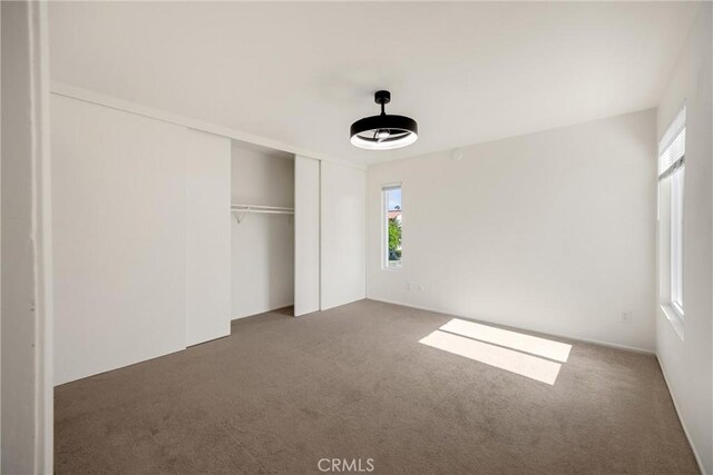 2521 W Sunflower Ave Unit R8, Santa Ana, CA 92704 - unfurnished bedroom with multiple windows, carpet, and a closet