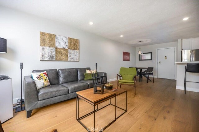 5585 E Pacific Coast Unit 141, Long Beach, CA 90804 - living room featuring light wood-style flooring and recessed lighting