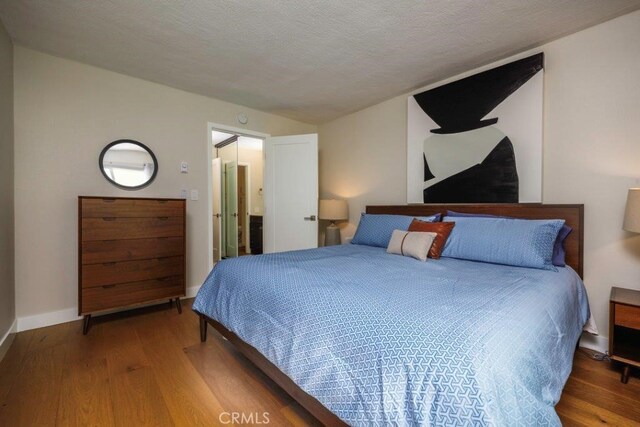 5585 E Pacific Coast Unit 141, Long Beach, CA 90804 - bedroom featuring wood finished floors and baseboards