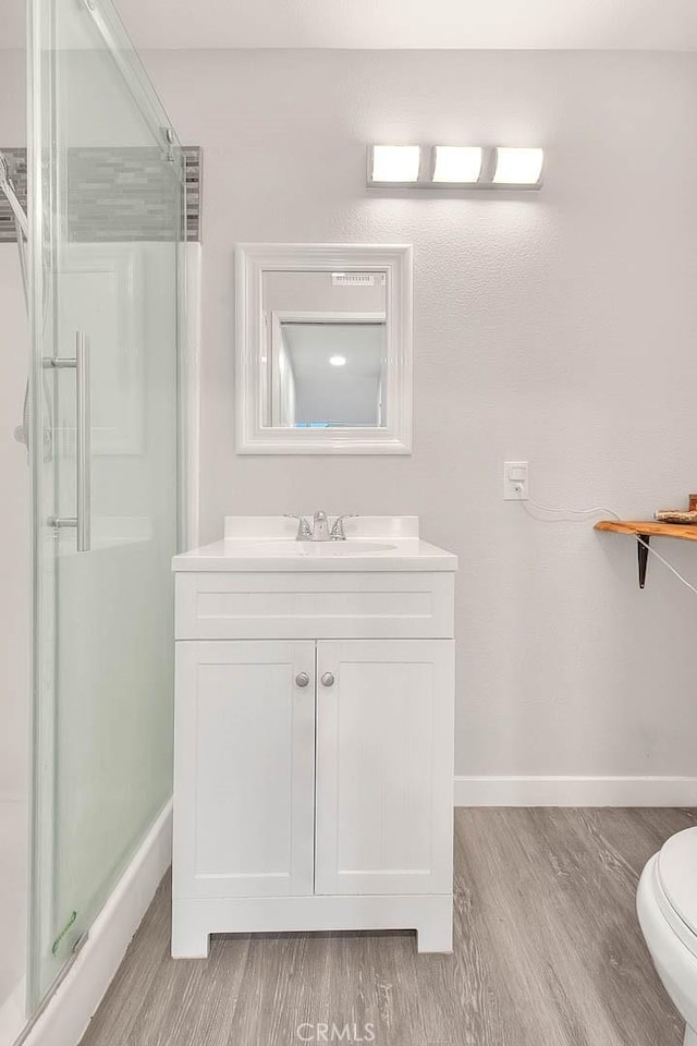 1068 Border Ave, Corona, CA 92882 - full bath featuring wood finished floors, a stall shower, and vanity