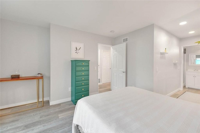 1068 Border Ave, Corona, CA 92882 - bedroom with light wood-type flooring, recessed lighting, and ensuite bathroom
