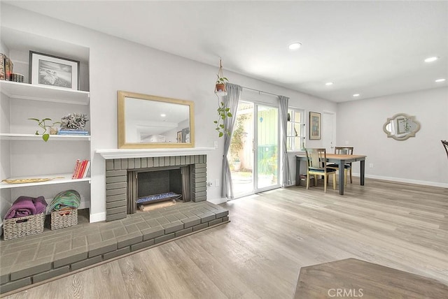 1068 Border Ave, Corona, CA 92882 - living area with wood finished floors, recessed lighting, and a fireplace