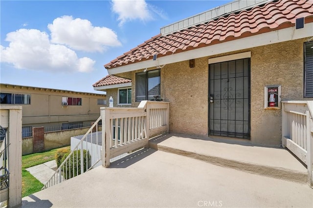 1657 E Kingsley Ave Unit B, Pomona, CA 91767 - view of exterior entry featuring a tiled roof and stucco siding
