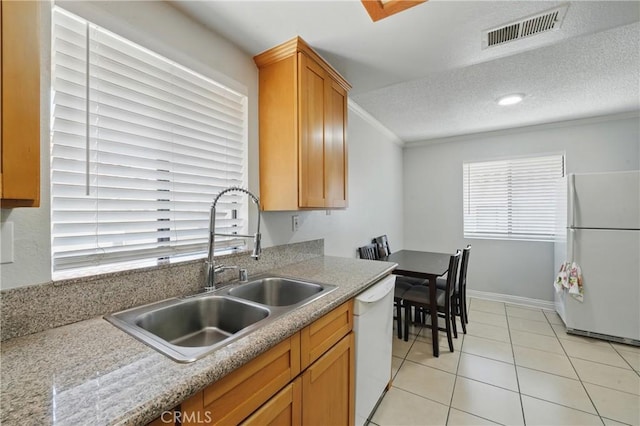 1657 E Kingsley Ave Unit B, Pomona, CA 91767 - kitchen featuring white appliances, crown molding, light tile patterned floors, a textured ceiling, and light countertops