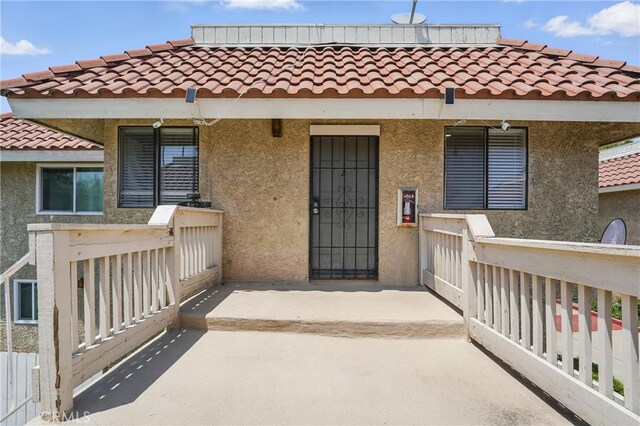 1657 E Kingsley Ave Unit B, Pomona, CA 91767 - doorway to property featuring stucco siding and a tile roof