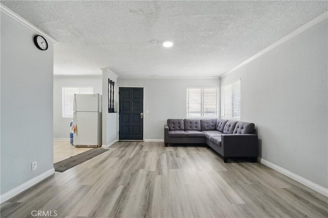 1657 E Kingsley Ave Unit B, Pomona, CA 91767 - living room with a textured ceiling, ornamental molding, and light wood-style flooring
