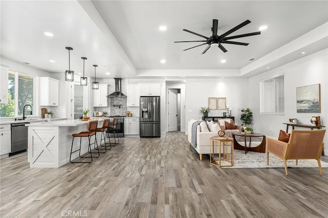 1340 Jeannie Ln, Paradise, CA 95969 - living room with light wood-style flooring, a ceiling fan, recessed lighting, and a tray ceiling