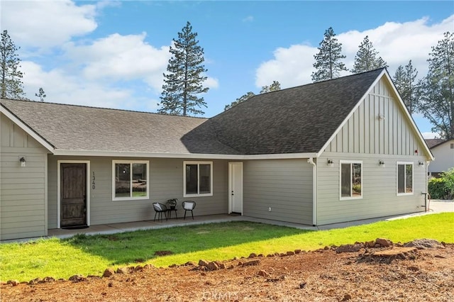 1340 Jeannie Ln, Paradise, CA 95969 - rear view of property featuring board and batten siding, a lawn, roof with shingles, and a patio