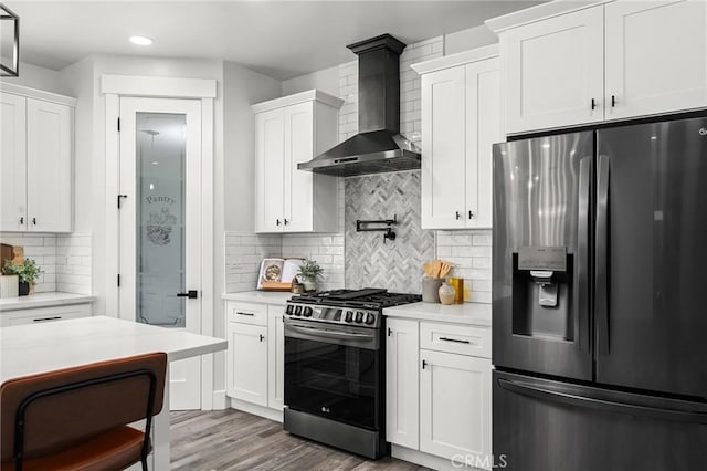 1340 Jeannie Ln, Paradise, CA 95969 - kitchen with appliances with stainless steel finishes, wall chimney exhaust hood, light countertops, white cabinets, and recessed lighting