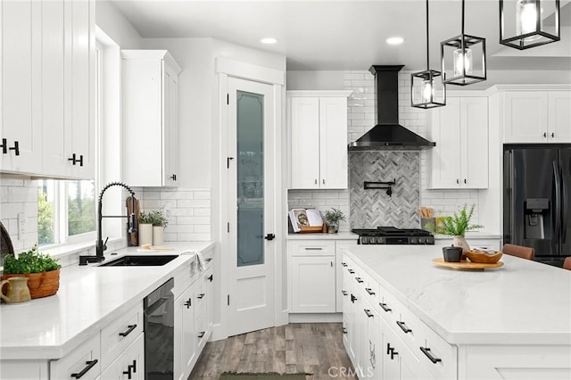 1340 Jeannie Ln, Paradise, CA 95969 - kitchen featuring black fridge with ice dispenser, wall chimney range hood, dishwasher, a center island, and white cabinets