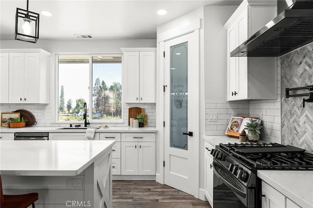 1340 Jeannie Ln, Paradise, CA 95969 - kitchen with wall chimney range hood, black range with gas cooktop, decorative backsplash, light countertops, and recessed lighting