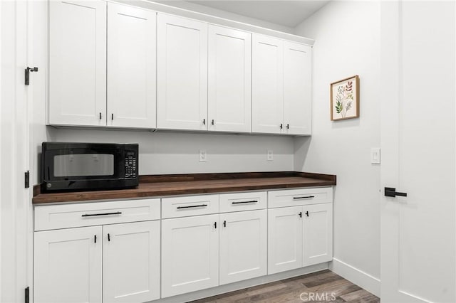 1340 Jeannie Ln, Paradise, CA 95969 - kitchen featuring black microwave, butcher block counters, wood finished floors, and white cabinetry
