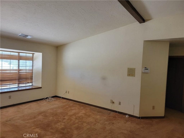 15440 Cactus St, Hesperia, CA 92345 - empty room featuring carpet flooring, beamed ceiling, and a textured ceiling