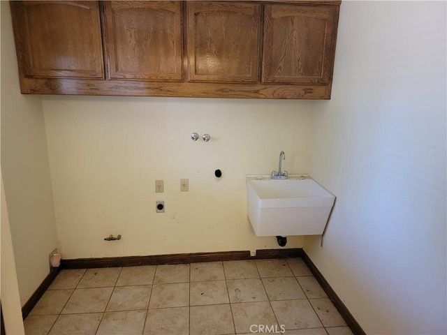 15440 Cactus St, Hesperia, CA 92345 - laundry area featuring cabinet space, electric dryer hookup, light tile patterned floors, and hookup for a gas dryer