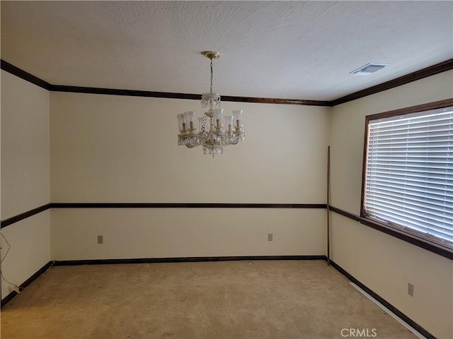 15440 Cactus St, Hesperia, CA 92345 - spare room featuring ornamental molding, a chandelier, light colored carpet, and a textured ceiling