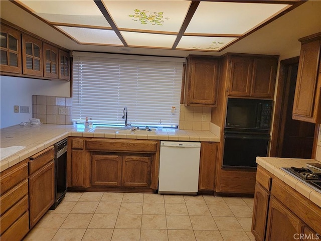 15440 Cactus St, Hesperia, CA 92345 - kitchen featuring black appliances, tile counters, decorative backsplash, and glass insert cabinets