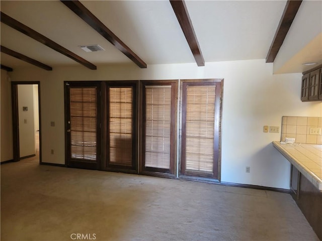 15440 Cactus St, Hesperia, CA 92345 - unfurnished dining area with beamed ceiling and carpet floors
