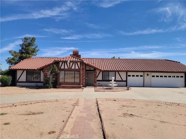15440 Cactus St, Hesperia, CA 92345 - view of front of house featuring a tile roof, stucco siding, and driveway