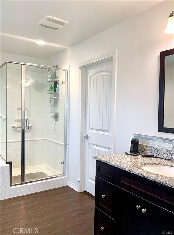 28667 Clearview St, Murrieta, CA 92563 - full bath with vanity, a stall shower, and wood finished floors