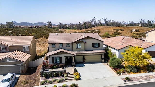 28667 Clearview St, Murrieta, CA 92563 - traditional-style home featuring driveway, an attached garage, stucco siding, and a mountain view