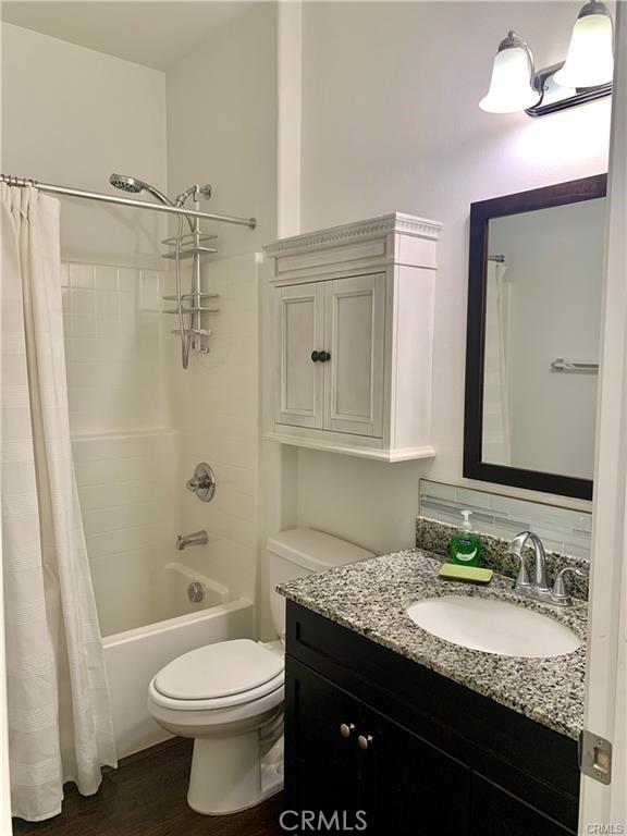 28667 Clearview St, Murrieta, CA 92563 - full bath with vanity, shower / tub combo with curtain, and wood finished floors