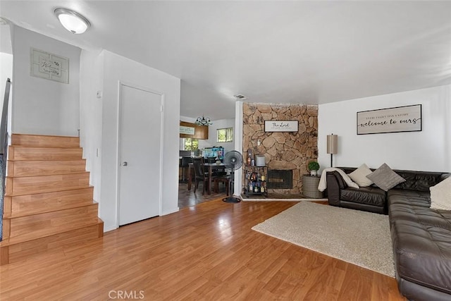 1553 Dennis Pl, West Covina, CA 91790 - living room with stairs, light wood-style flooring, and a fireplace