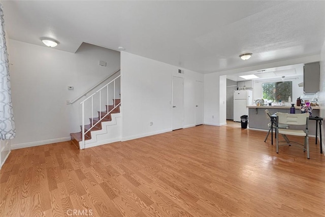 1553 Dennis Pl, West Covina, CA 91790 - living room with light wood-style floors and stairway