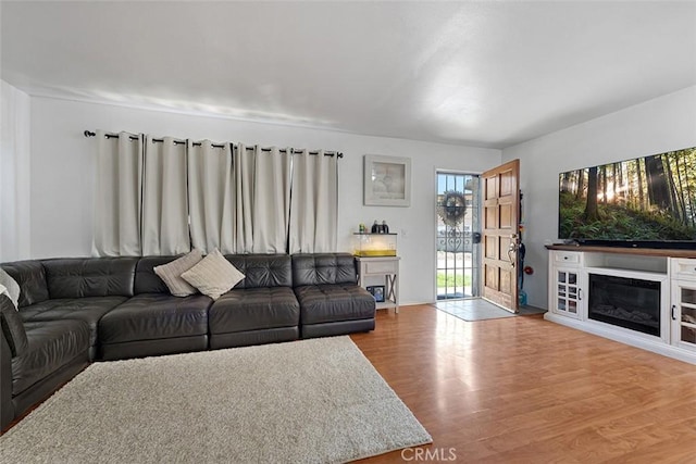 1553 Dennis Pl, West Covina, CA 91790 - living area featuring wood finished floors and a glass covered fireplace